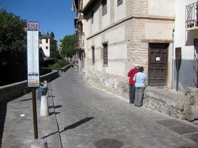 Una pareja lee el panel informativo del Bañuelo, en cuya puerta se puede ver un cartel de cerrado por obras. GiM 2014