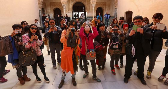 Un grupo de turistas fotografía la Alhambra. / m. zarza